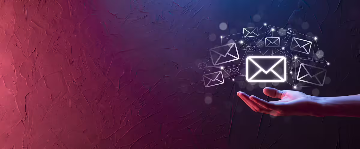 hand with email icons floating above it