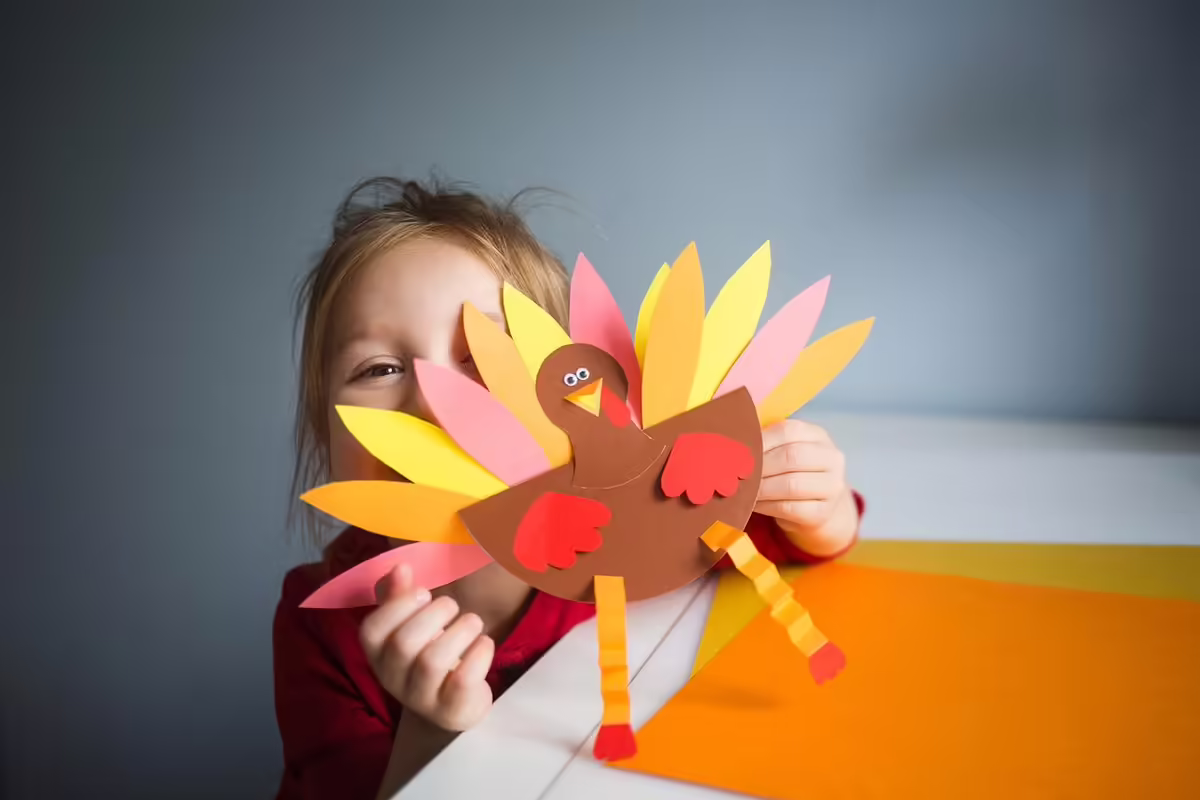 kid with a cutout turkey