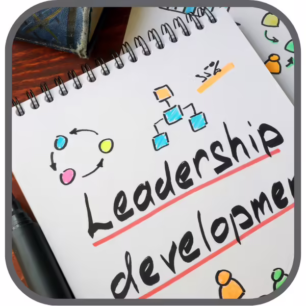 notepad with the words leadership development written on it