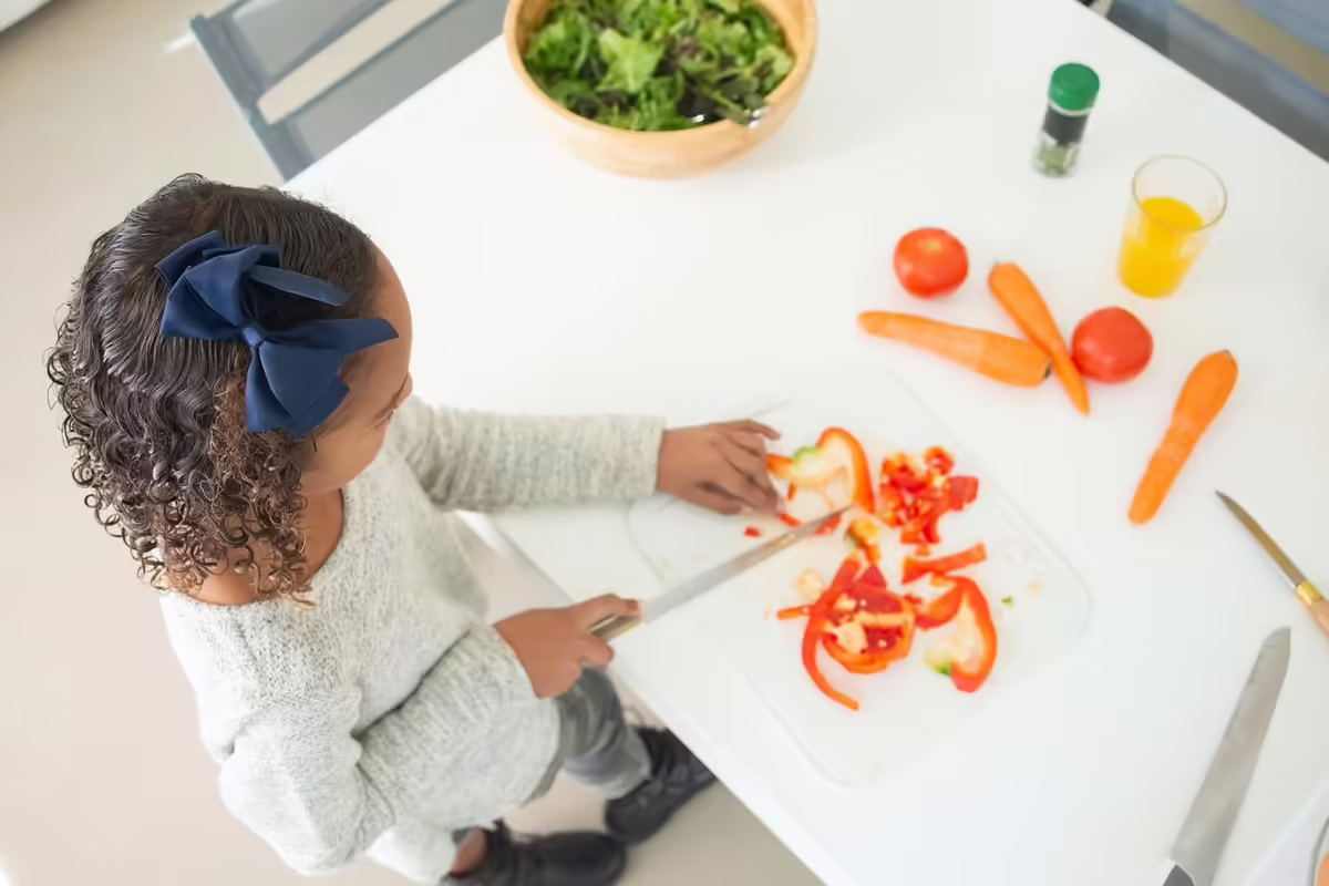 girl cutting vegetables