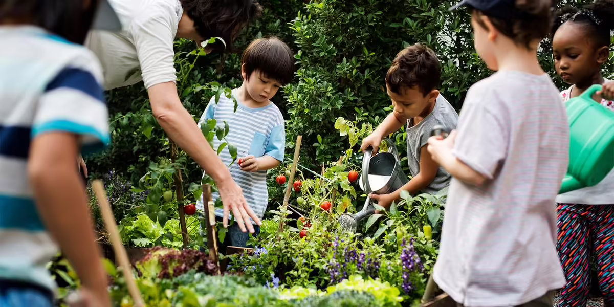young kids tending a school garden