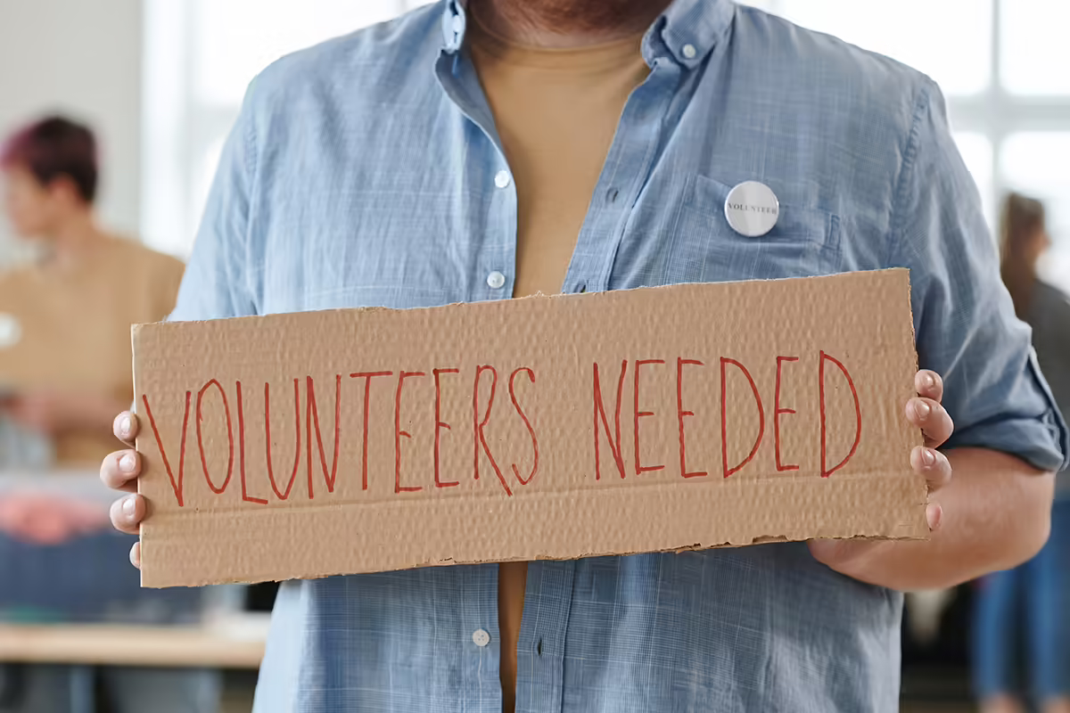 volunteer holding sign