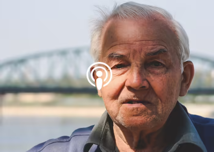 older man in front of bridge