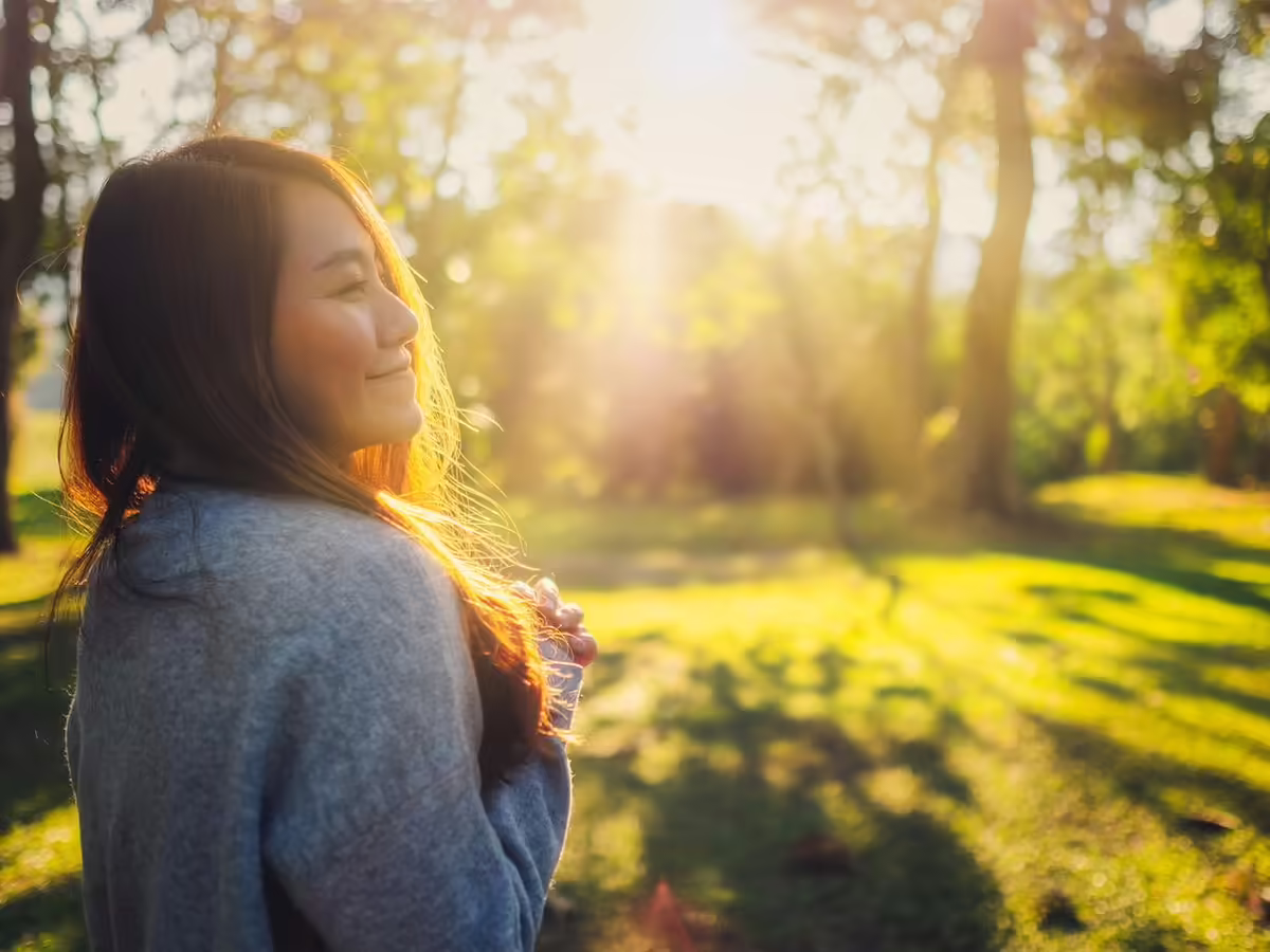 smiling woman in park at sunset