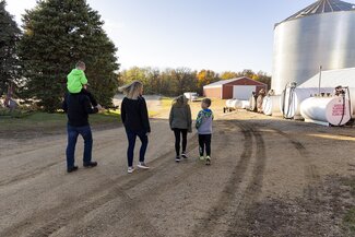 Michael and his family walking on farm