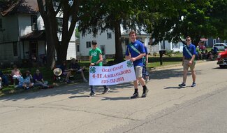 Youth walking with banner.