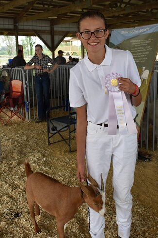 girl in white with ribbons and goat