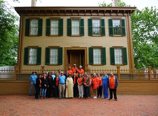 Group of people posed in front of the Lincoln House.