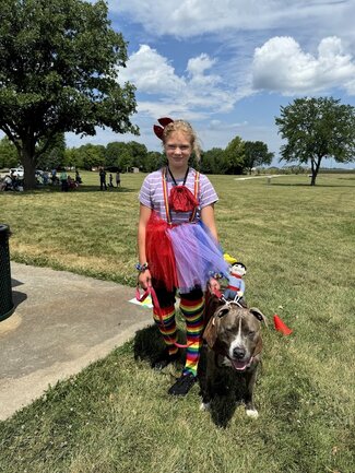 Lucy Stivers with their dog dressed as rodeo clowns