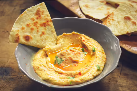 Bowl of hummus with pita bread