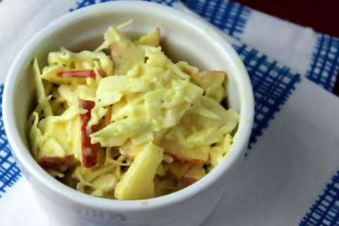 apple cabbage slaw in white bowl