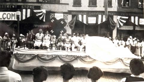 Black and white photo with 4-H members on float.