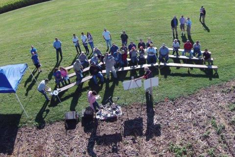 aerial drone photo of people standing in field 