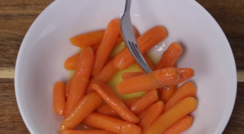 Baby carrots on white plate
