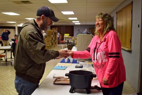 Cheryl Russel handing a food pantry client a food sample