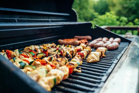 kebabs of food on an open grill