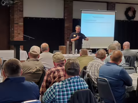 Hans Schmitz stands in front of the gathered attendees of the Bi-State Crops Conference