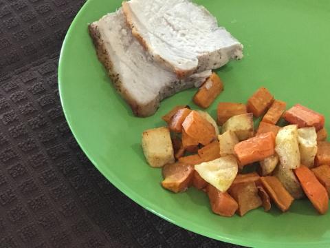 Pork roast slices with fall medley on green plate