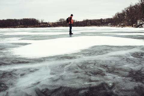 man on frozen pond