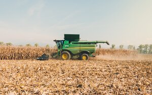 Photo of a combine harvesting corn.