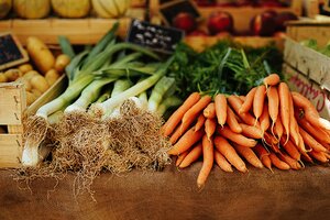 Celery stalks and carrots in a market stall