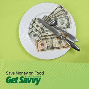 dinner plate with cash sitting under the silverware. Save money on food
