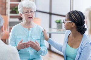 younger woman speaking to older woman