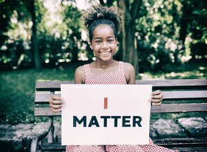 young black person holding sign that reads I matter
