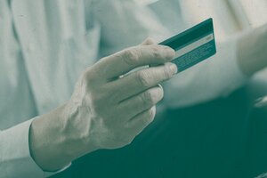 person holding a credit or debit card