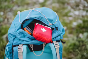 a backpack holding a first aid kit