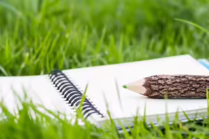 a notebook open on grass