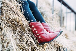 young person with red boots on hay ride