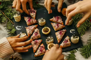 Board with healthy appetizers on a table with greenery