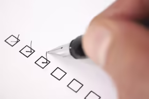 Pen marking checks in boxes in a column