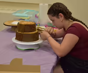 youth decorating a cake