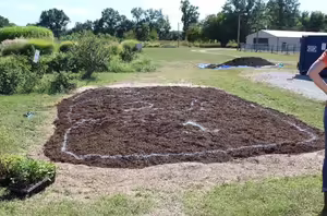A bare soil patch with markings on it