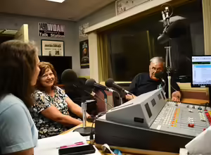 Radio host and Master Gardener guests sit in a radio studio