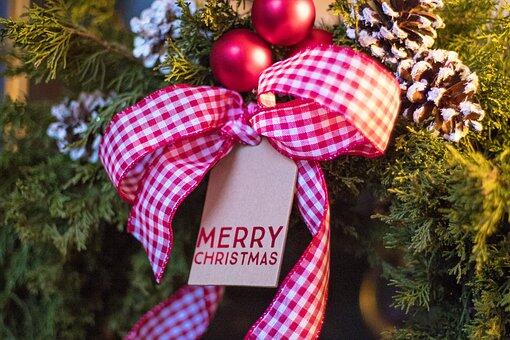 Evergreens with gingham checked ribbon and Merry Christmas tag