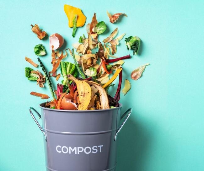 vegetable and fruit scraps falling into compost bucket