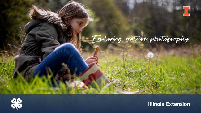 teenage girl sitting in grass taking photo of a dandelion with her smartphone