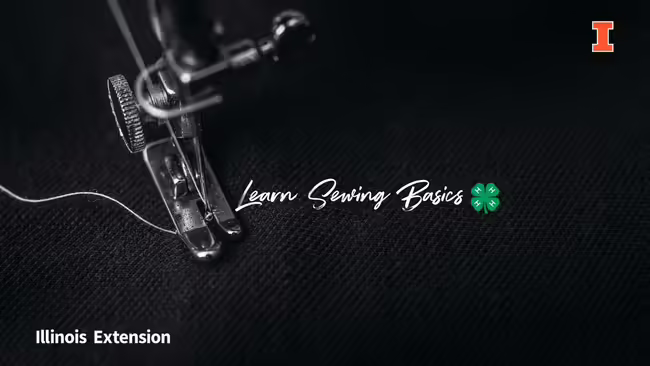 black background with a close up of a sewing machine foot and white thread