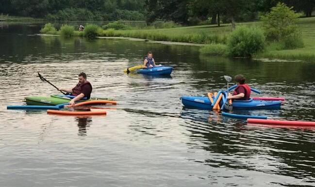 family kayaking on a lake
