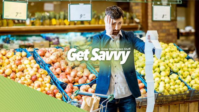 Get Savvy: man in grocery store looking distressed at a long grocery bill.