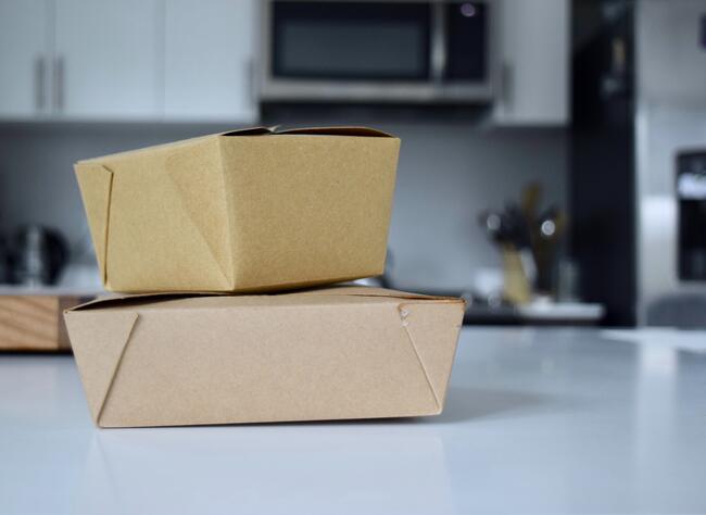 2 cardboard take out container in white kitchen