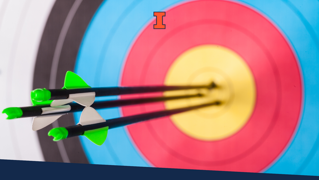 Archery target with three arrows in the bullseye area