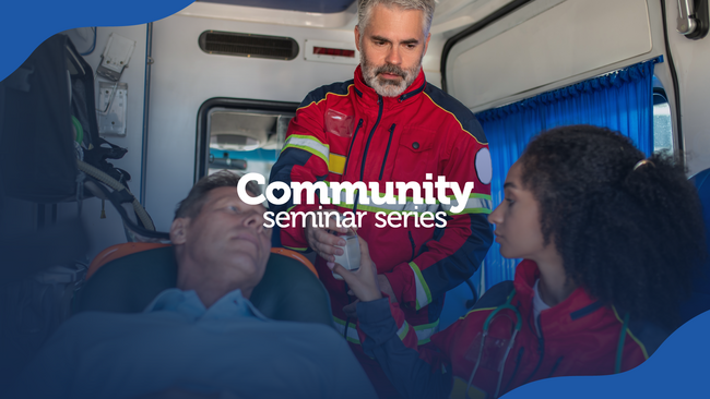 two emergency service workers talking with a patient in an ambulance