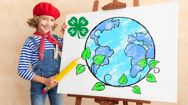 girl in red beret with a large drawing of the earth and leaves