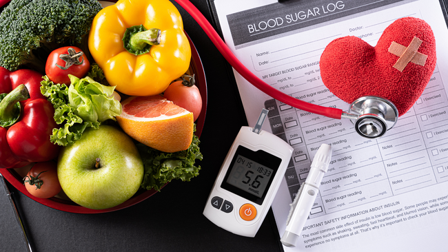 Image of fruits and vegetables next to diabetes management tools
