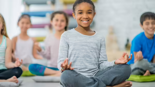 kids sitting crosslegged on the floor