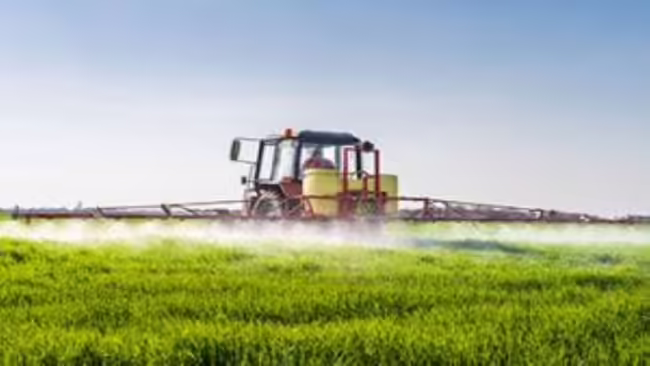 tractor spraying field